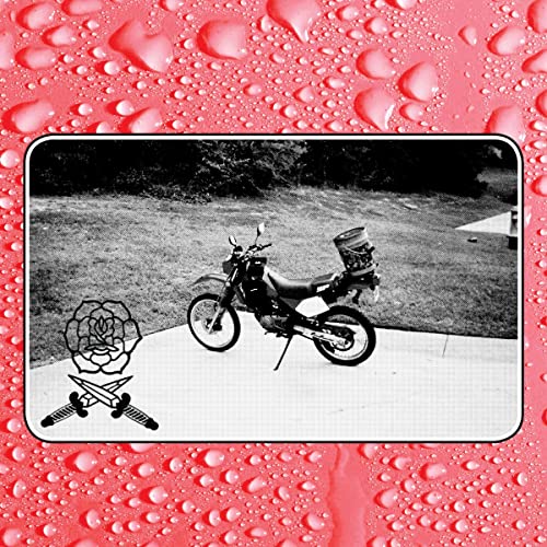 Black and white photo of a motorcycle with a drum on the back.