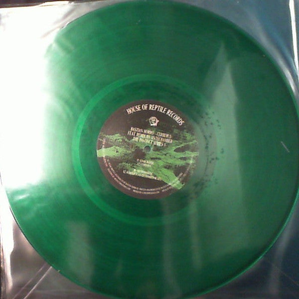 Green vinyl record with a central label featuring text and imagery.