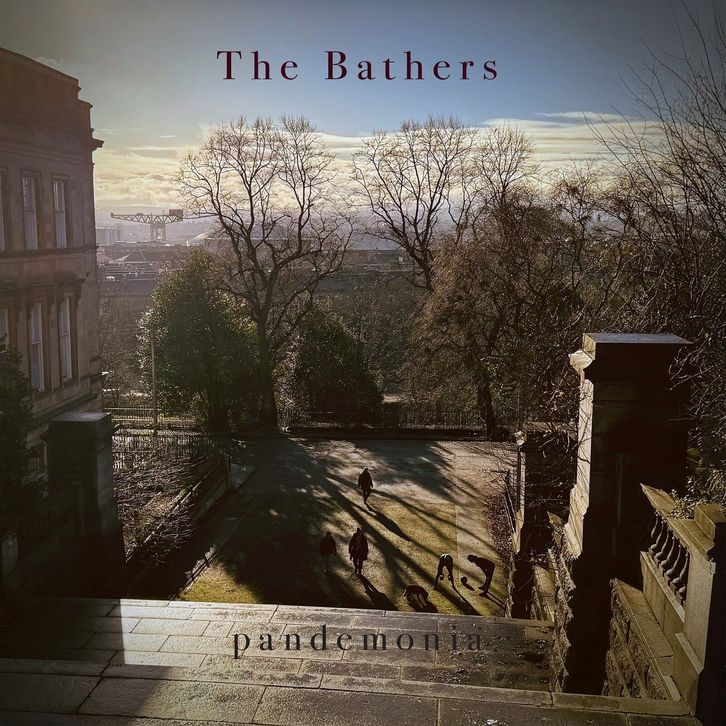 Album cover: a cityscape viewed from stone steps with silhouetted figures.