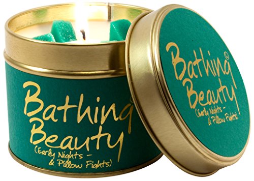 Green tin candle with gold lettering and green gummy bear embeds, lit.