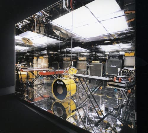 CD cover with mirrored image of a drum kit and amplifiers.