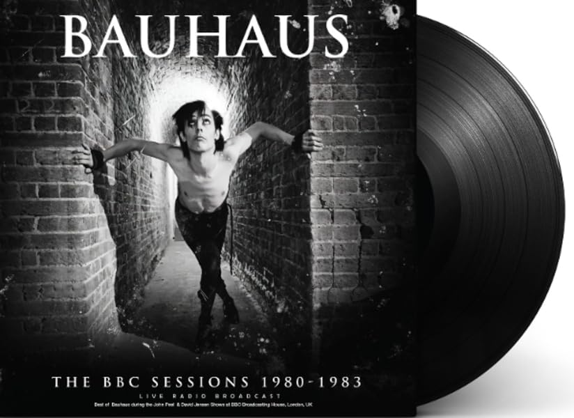 Bauhaus album cover with a vinyl record; black and white, brick hallway.