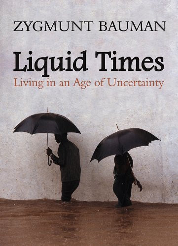 Book cover for Liquid Times by Zygmunt Bauman showing two people walking with umbrellas.