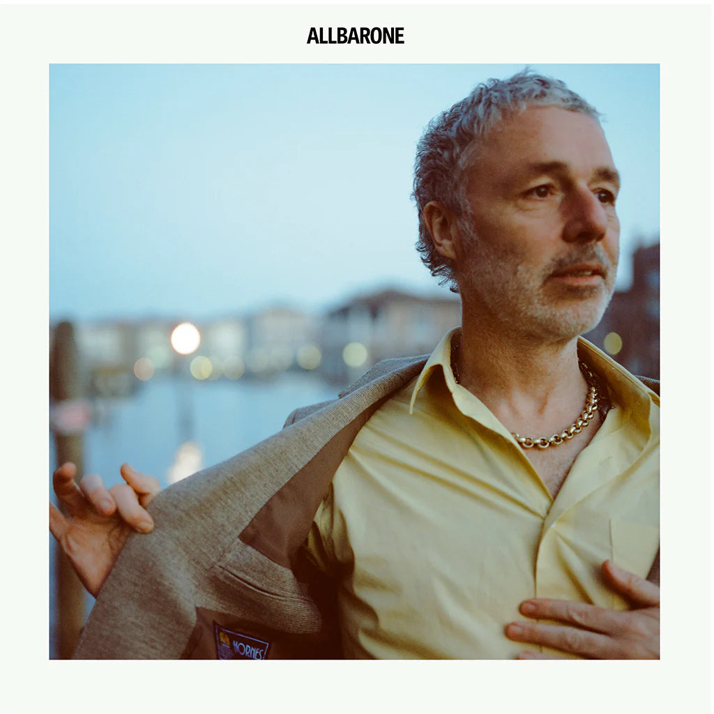 Baxter Dury album cover: man in yellow shirt and tweed jacket.