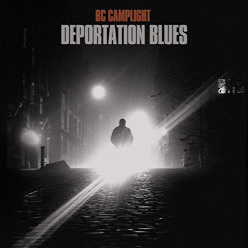 Black and white album cover with a lone figure in a foggy street.