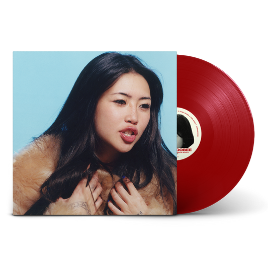 Album cover featuring a woman in a fur coat next to a red vinyl.
