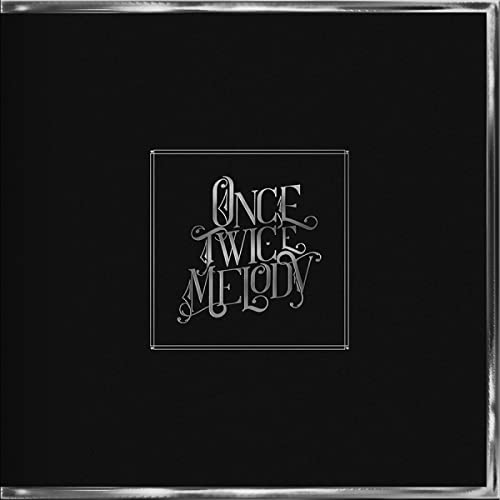 Black CD cover with silver text reading "Once Twice Melody" inside a frame.