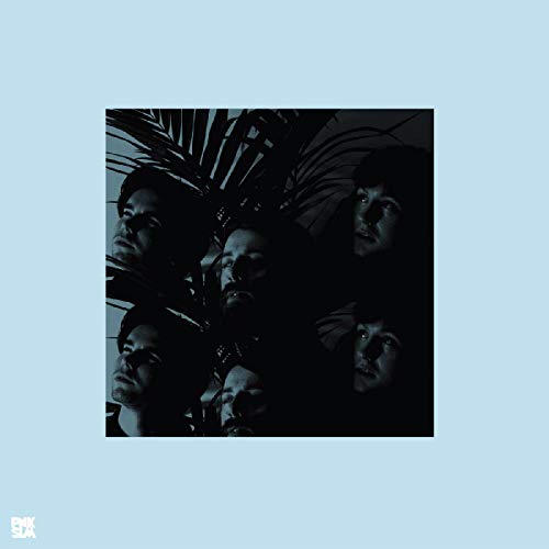 A square album cover showing multiple dark, shadowed faces amidst palm leaves on light blue.