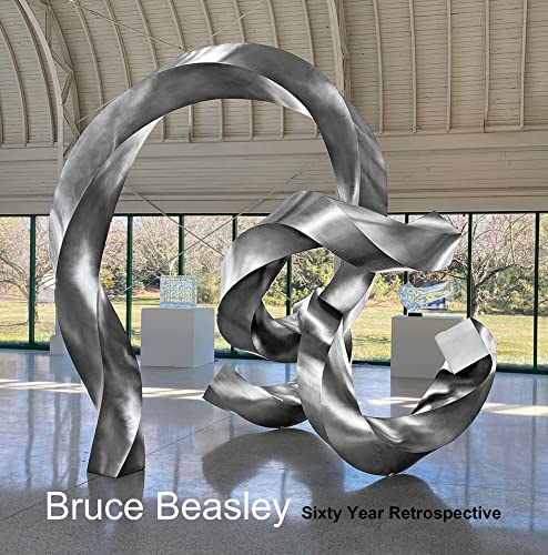 Large, polished metal sculpture with flowing curves in a bright gallery space.