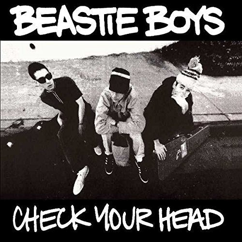 Black and white album cover featuring the three members of Beastie Boys sitting outdoors.