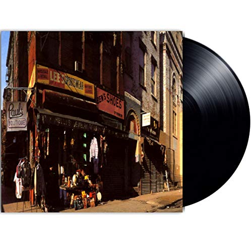 "Vintage storefront with 'Paul's Boutique' sign, clothing, and jewelry on display outside."