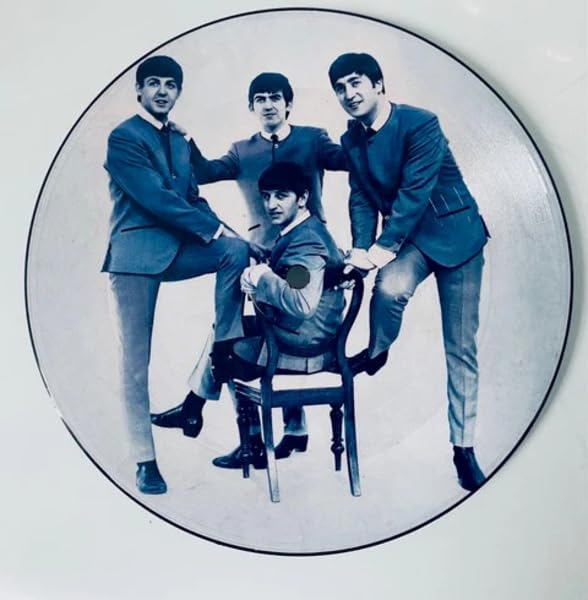 The Beatles in suits pictured on a circular vinyl record.