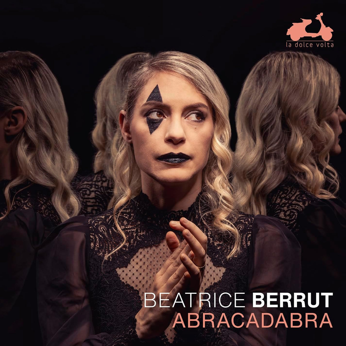 Beatrice Berrut album cover, woman with star makeup and dark clothing.