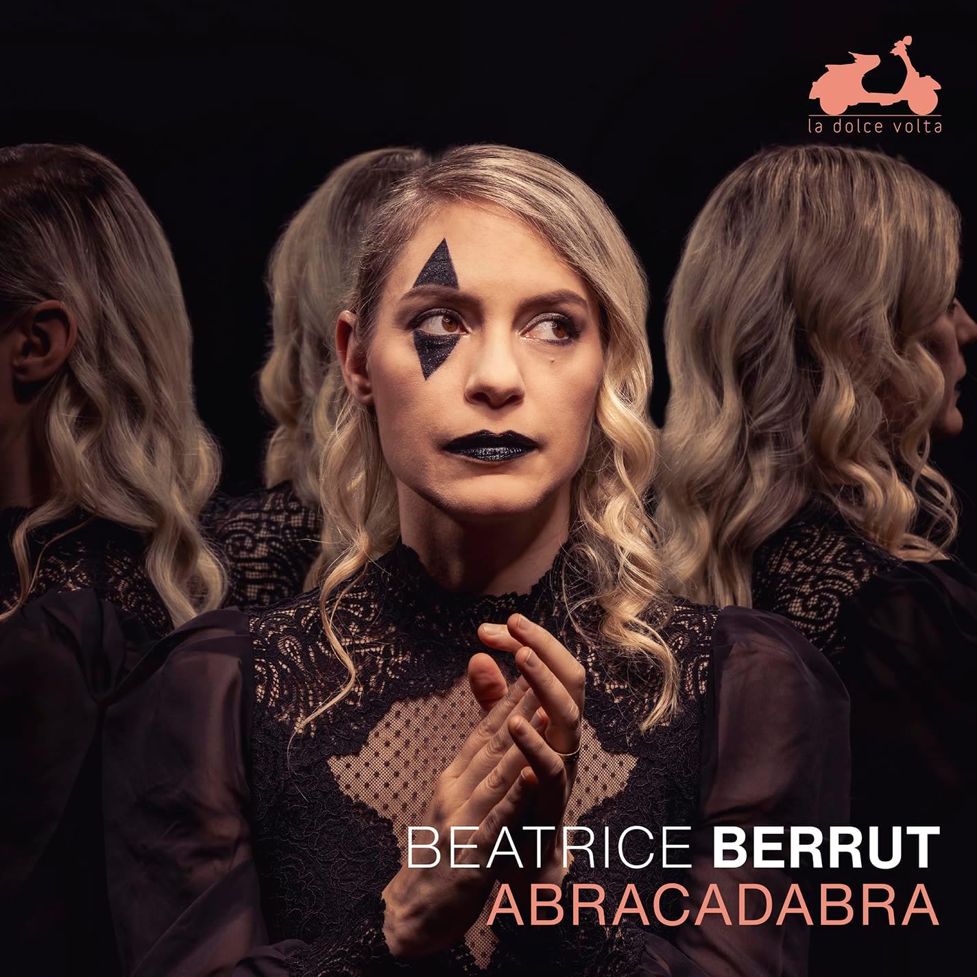 Beatrice Berrut album cover, woman with star makeup and dark clothing.