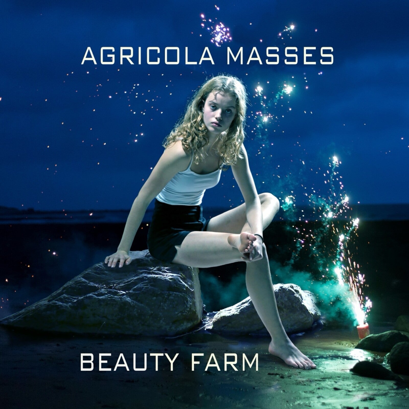 CD cover: woman on a rock with fireworks at night.