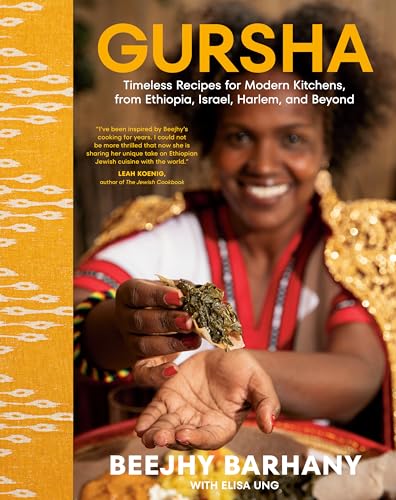 Cookbook cover featuring Beejhy Barhany holding Ethiopian food, smiling.