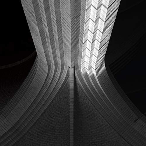 Black and white architectural detail showing converging brick arches and geometric patterns.
