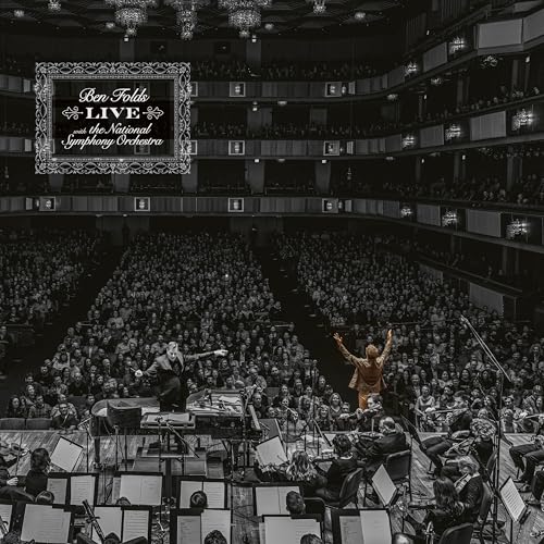 Black and white concert hall interior with orchestra and performer.