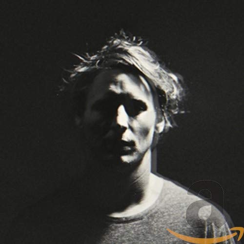 Black and white portrait of a man with messy hair, CD design.