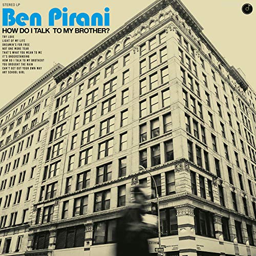 Album cover showing a tall city building with a blurred figure in the foreground.