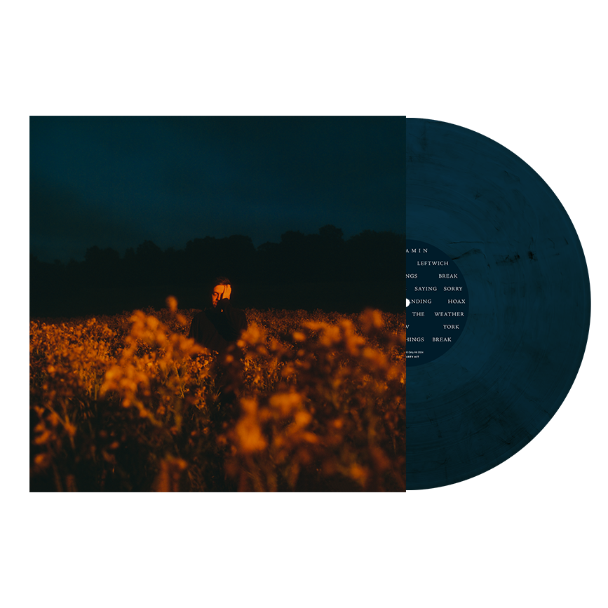 Album cover featuring a person in a field at dusk next to dark vinyl.