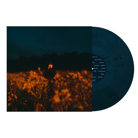 Album cover featuring a person in a field at dusk next to dark vinyl.