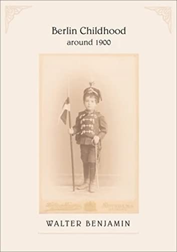 Vintage photograph of a young boy in military attire with a flag.
