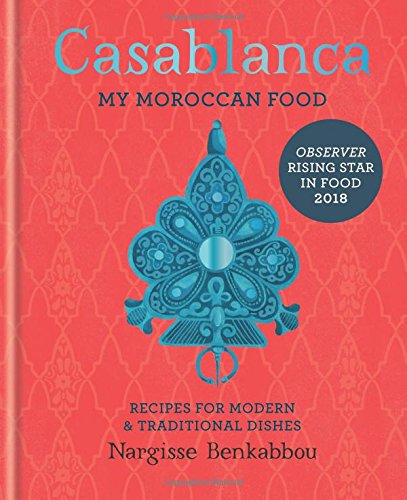 Red cookbook cover with blue title, ornate design, and yellow endorsement sticker.