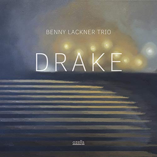 "Album cover with 'DRAKE' in white text, abstract background with yellow lights."