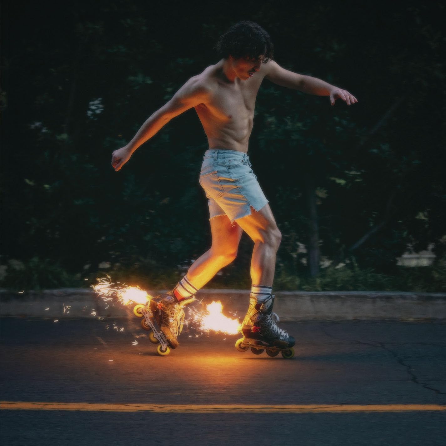 Man rollerblading at night with sparks flying from the wheels.