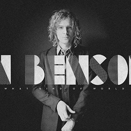 Black and white album cover featuring a man with shoulder-length wavy hair wearing a suit.