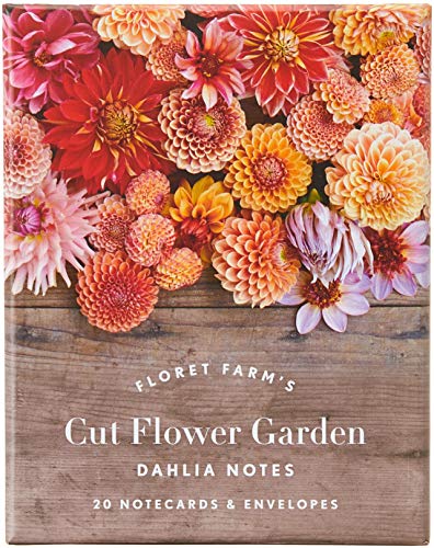 A box of dahlia notecards featuring a floral arrangement over a wood grain background.
