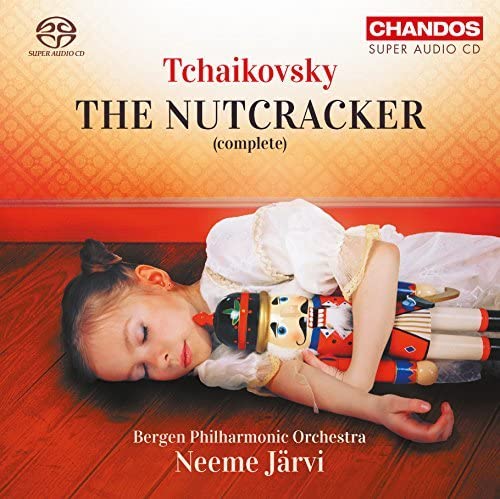 CD cover: girl with nutcracker dolls, red and gold background.