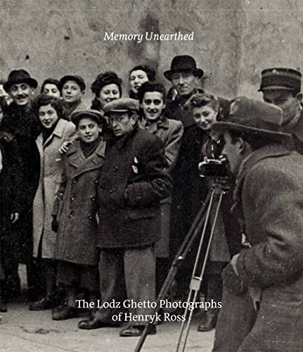 Black and white photo of people in winter clothing, a photographer present.