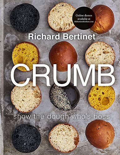 Cookbook cover with various breads, cut open to show the crumb.