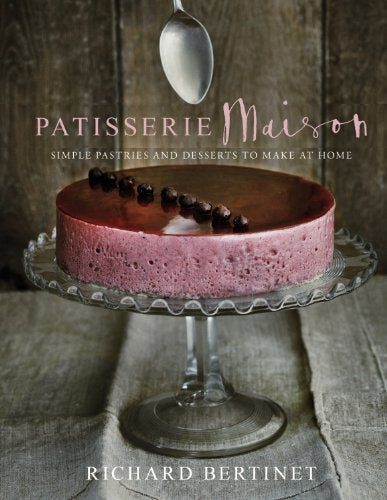 Cookbook cover featuring a glossy red berry cake on a glass stand.