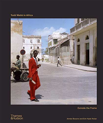 Book cover: man in red suit on a street in Africa.