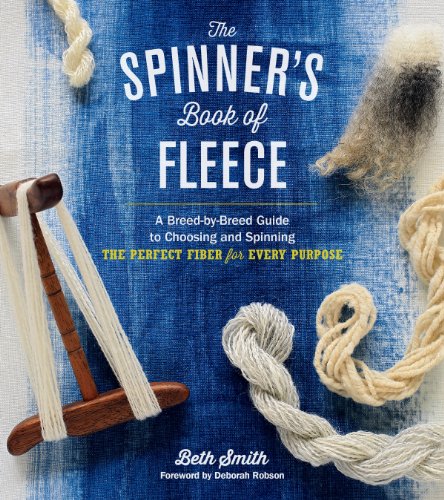 Book cover with yarn, spinning tools, and raw fleece on blue fabric.