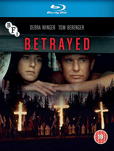 Blu-ray cover for Betrayed featuring Debra Winger and Tom Berenger above burning crosses.