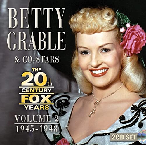 Portrait of Betty Grable with blonde hair and a pink flower, album cover art.