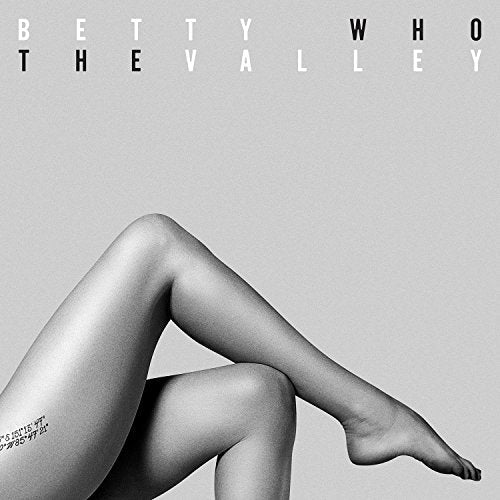 Black and white album cover featuring a person's legs against a grey background.
