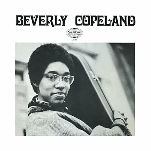 Black and white portrait of Beverly Copeland with a guitar case.