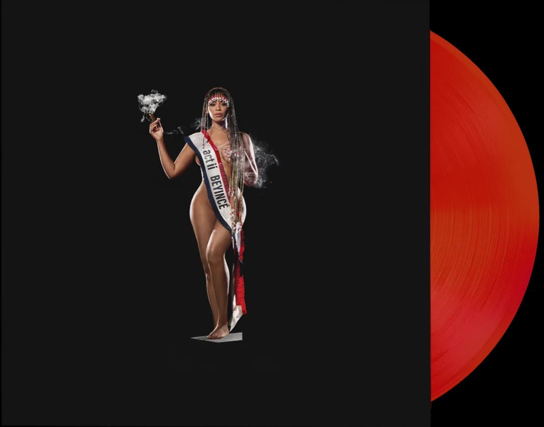 Beyonce in a pageant sash, with a red vinyl record beside her.