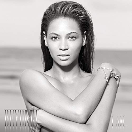 Black and white portrait of Beyoncé, wet hair, with jewelry.