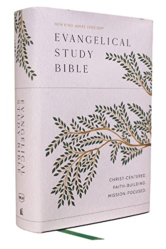 White hardcover Bible with gold-leaf branch design and red page edges.