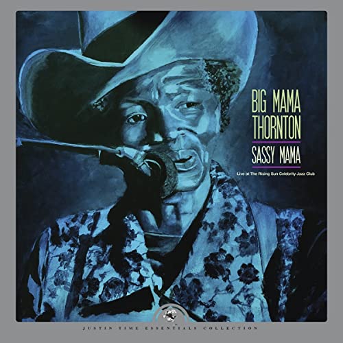 Big Mama Thornton in a cowboy hat singing into a microphone.