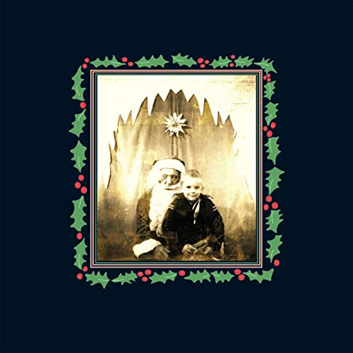 Sepia-toned portrait of Santa Claus with a child, framed by holly.