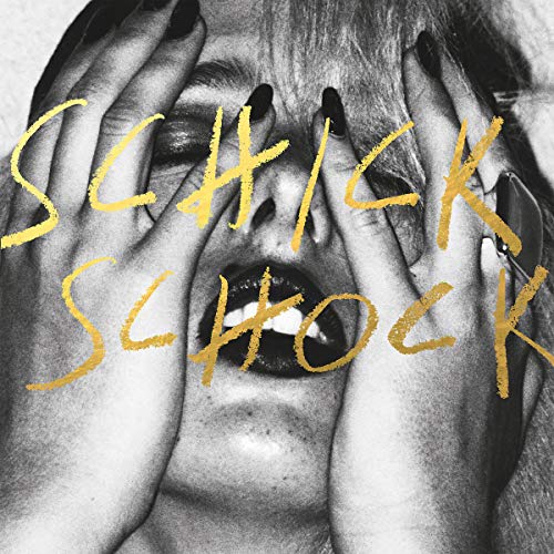 Black and white close-up of a face with gold text overlaying it.