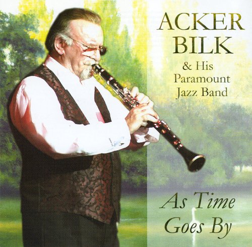 Acker Bilk playing the clarinet against a blurred outdoor park background.