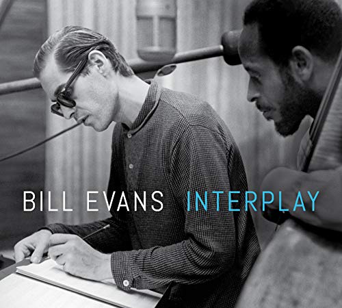 Black and white photo of Bill Evans at a piano, album cover.